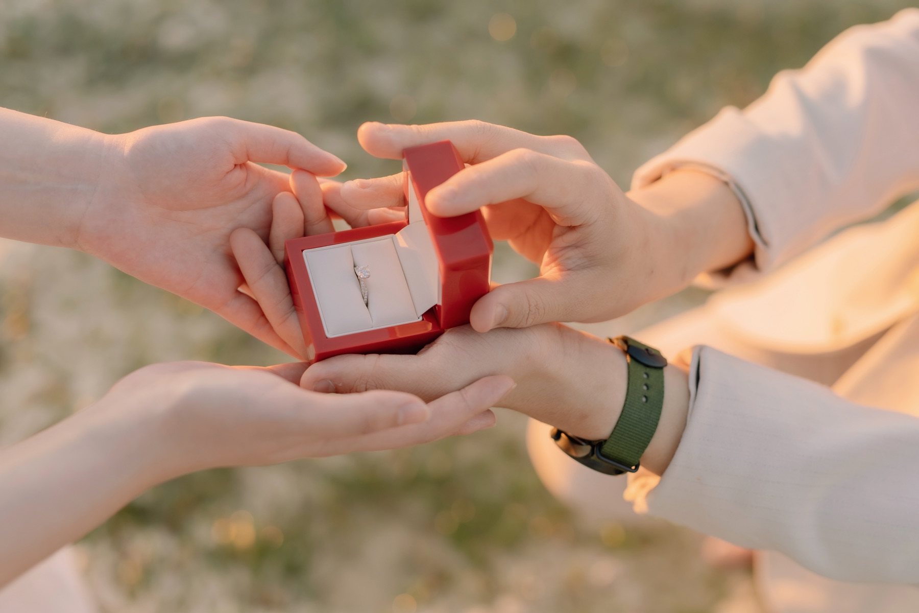Rey placing a ring on Feli's hand in warm afternoon light