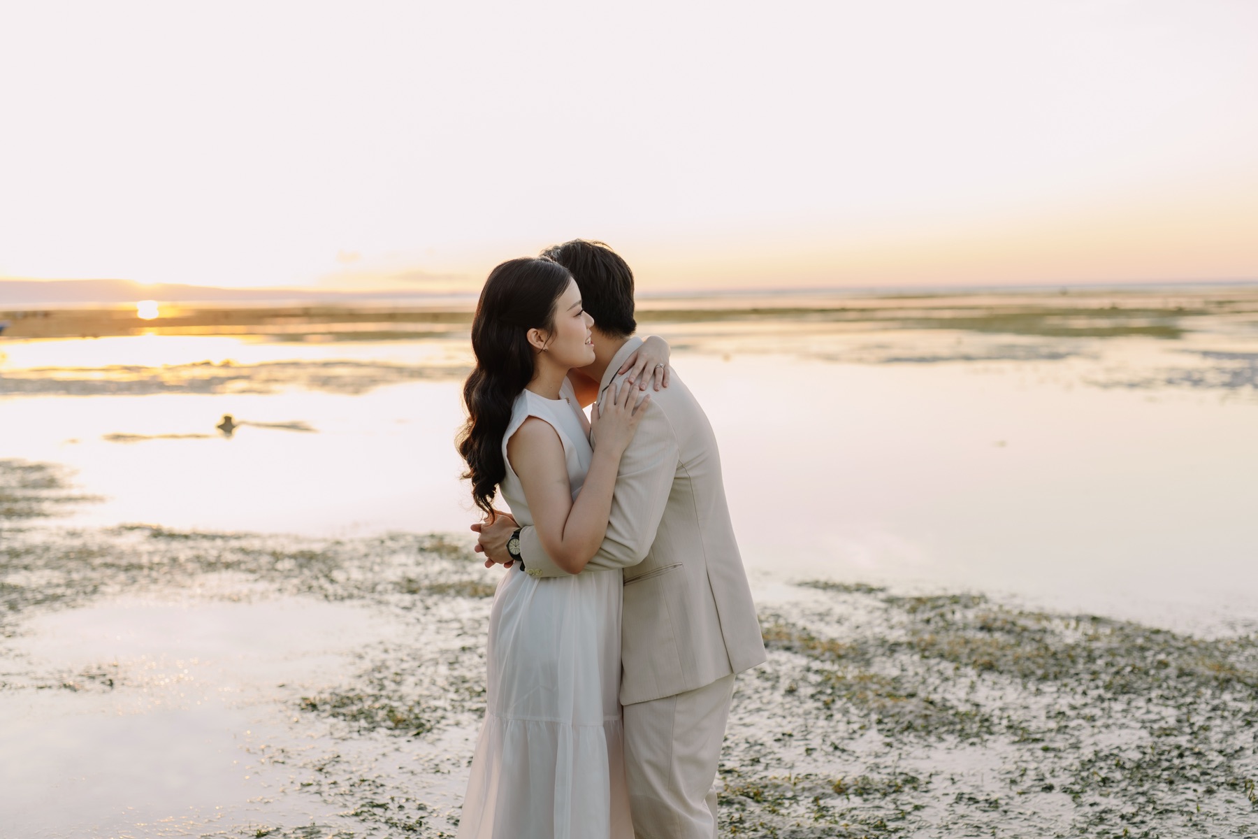 Rey and Feli sharing a close kiss on a softly lit beach