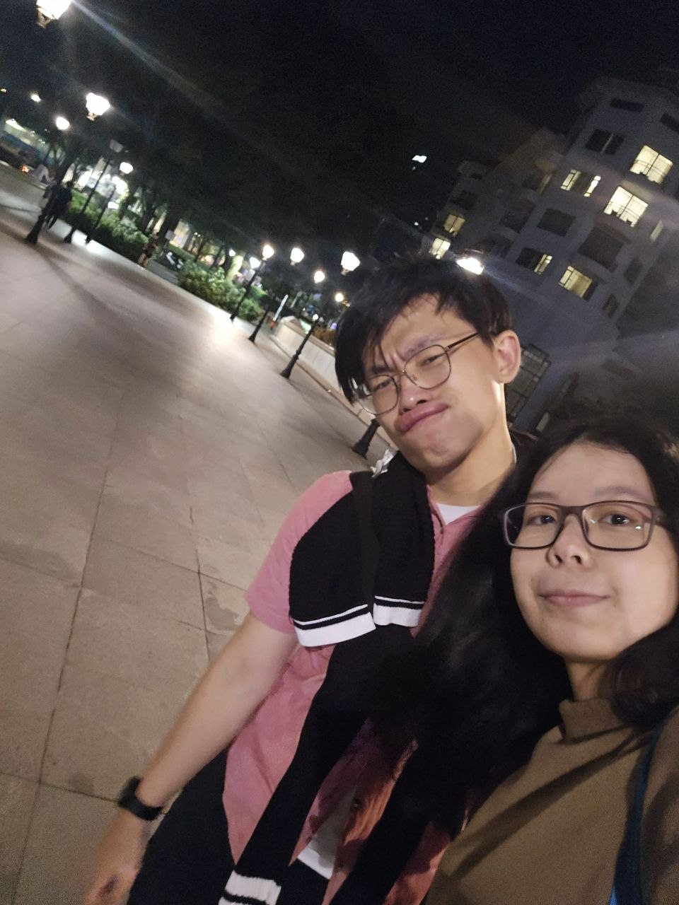 Rey and Feli taking a selfie during a night walk outdoors
